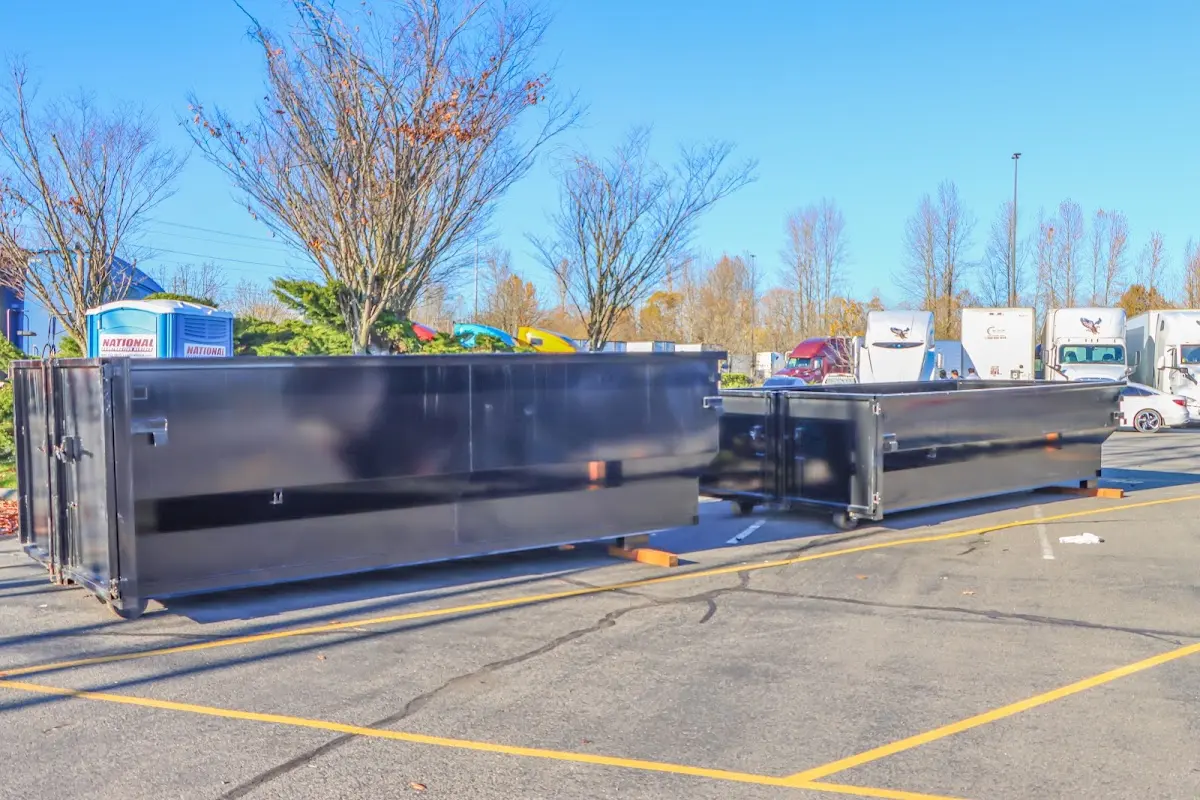 Professional dumpster rental service with roll-off container on residential driveway in Kaiminani